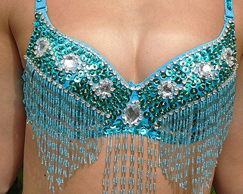 Gold bra with turquoise sequins and silver rhinestones.