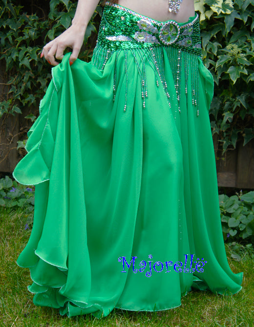 Green skirt with ruffles on the side. With slits on the sides