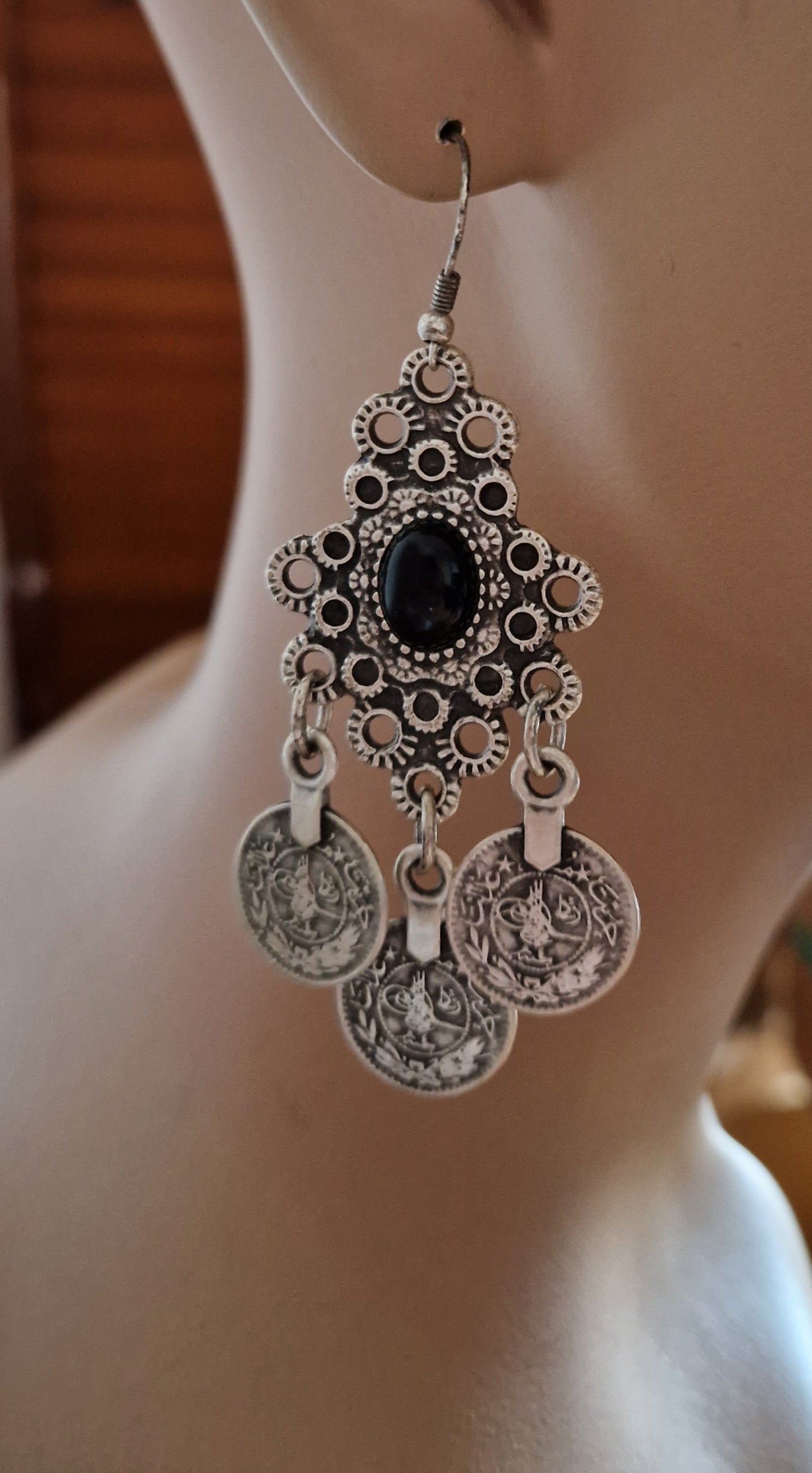 Silver-colored earrings with coins