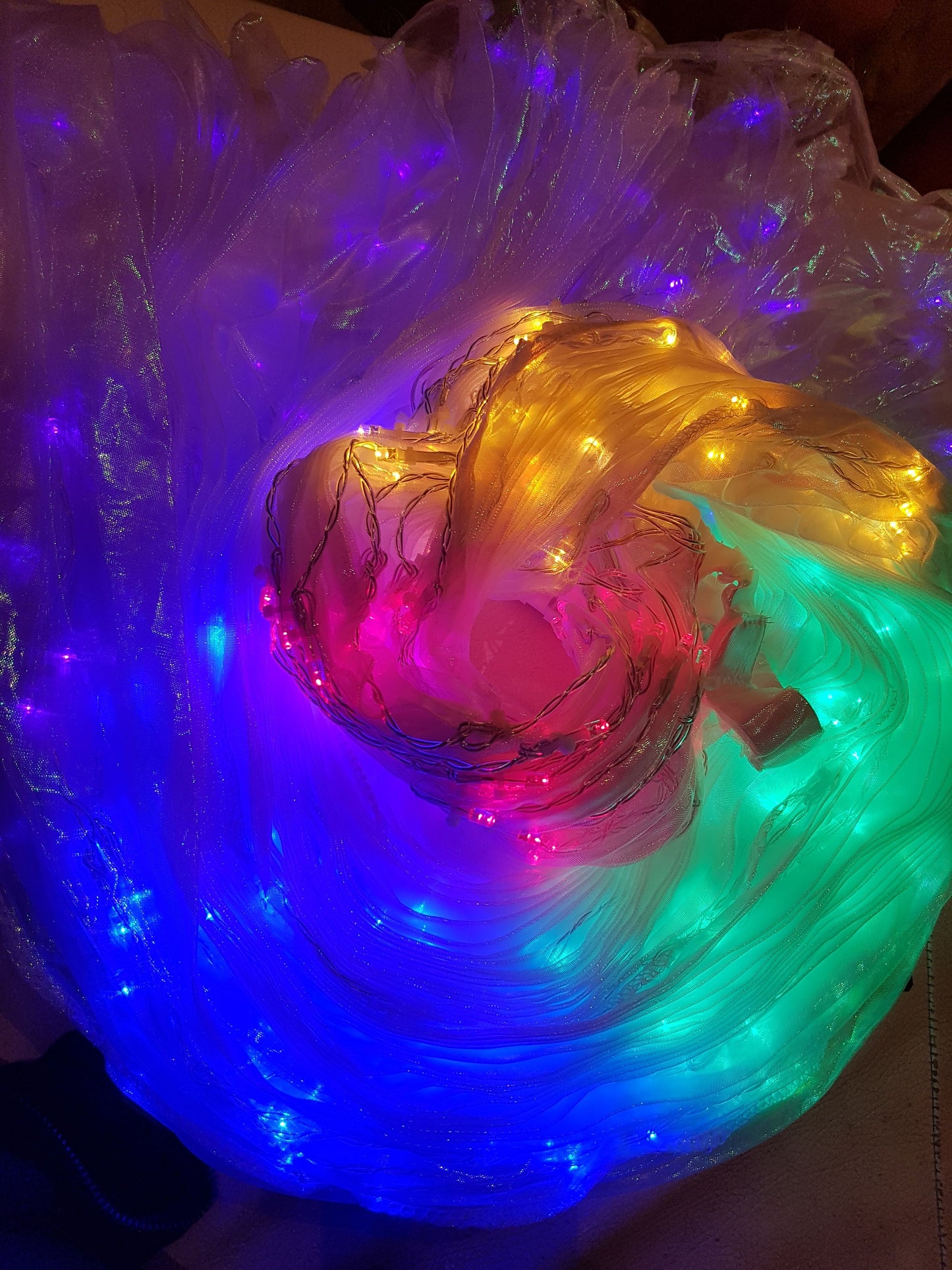 Isis Wings organza (translucent) in white mother of pearl with rainbow led lights.