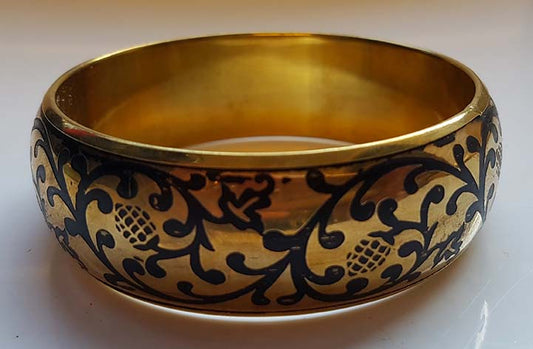 Gold-colored bracelet with black elements