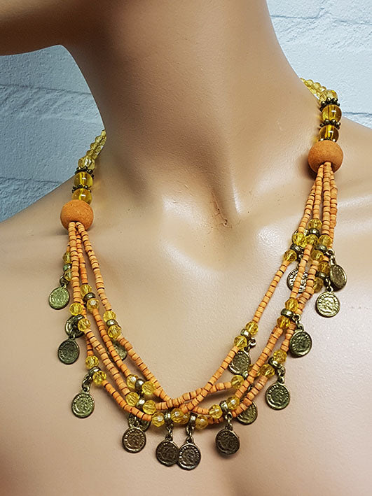 Beautiful necklace with soft orange beads and old coins