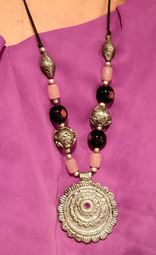 Necklace with pink stones and amulet
