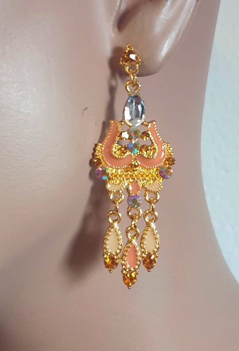 Beautiful gold-colored earrings with orange, stud earrings.